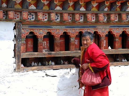 Photograph of woman and prayer wheels, Paro, Bhutan