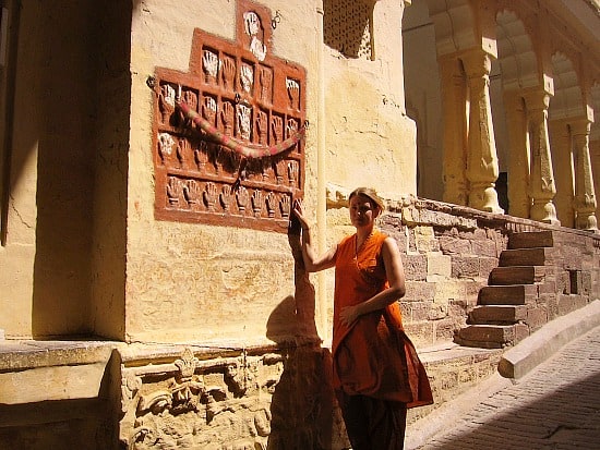 Me, touching sati prints at Jodhpur Fort, India