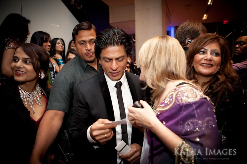 Caught in the act! Me handing Shahrukh Khan my card and reminding him we have met before. Photo by Andrew Adams of Katha Images.