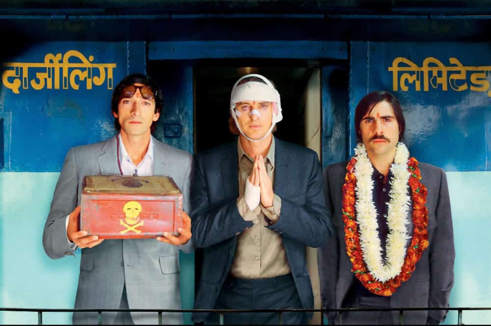 three men on a train in India