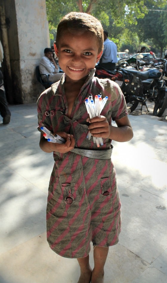 Street Girl in Janpath, Delhi, India selling pens