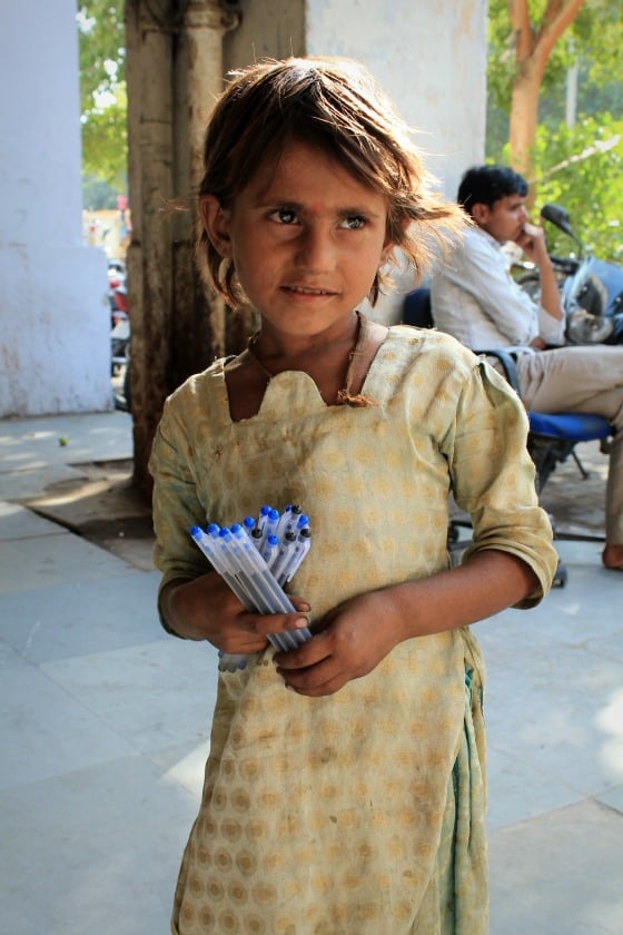 Girl selling pens on the street in Janpath, Delhi, India