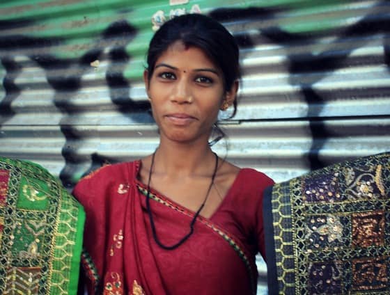 Woman selling tapestries and textiles on the street in Janpath, Delhi, India