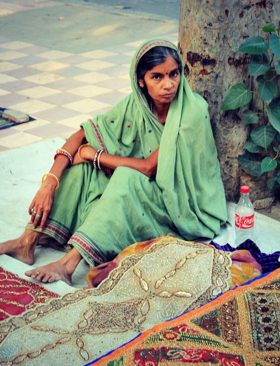 Shopping in India: Woman selling textiles in Janpath street market, Delhi, India