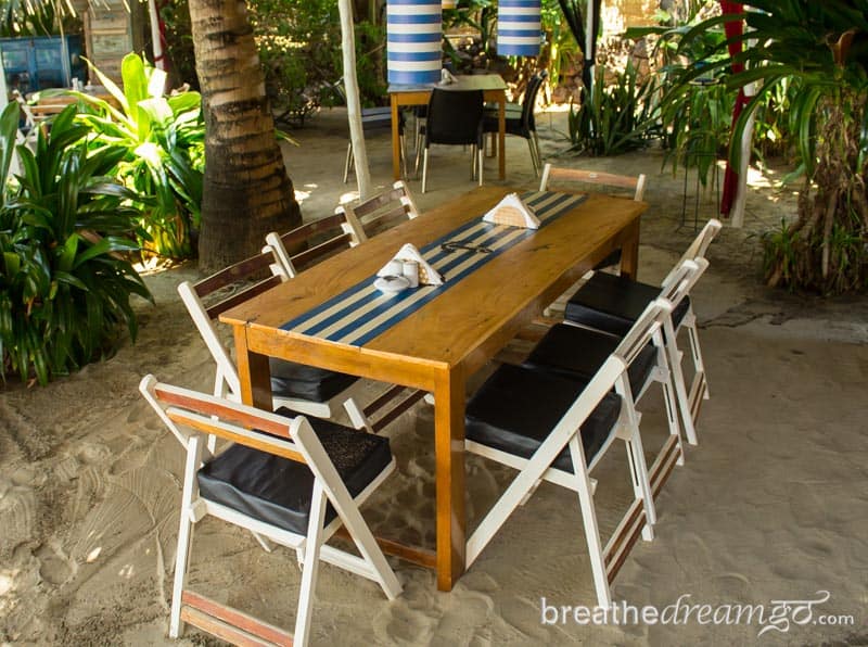 Table with eight chairs on the sand in Goa