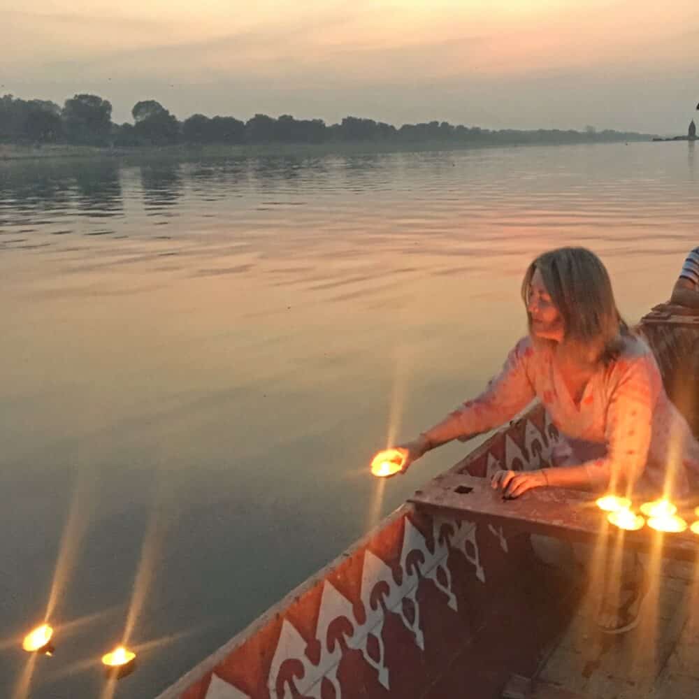 Releasing light-filled diyas into the Narmada River in Maheshwar, Madhya Pradesh, India