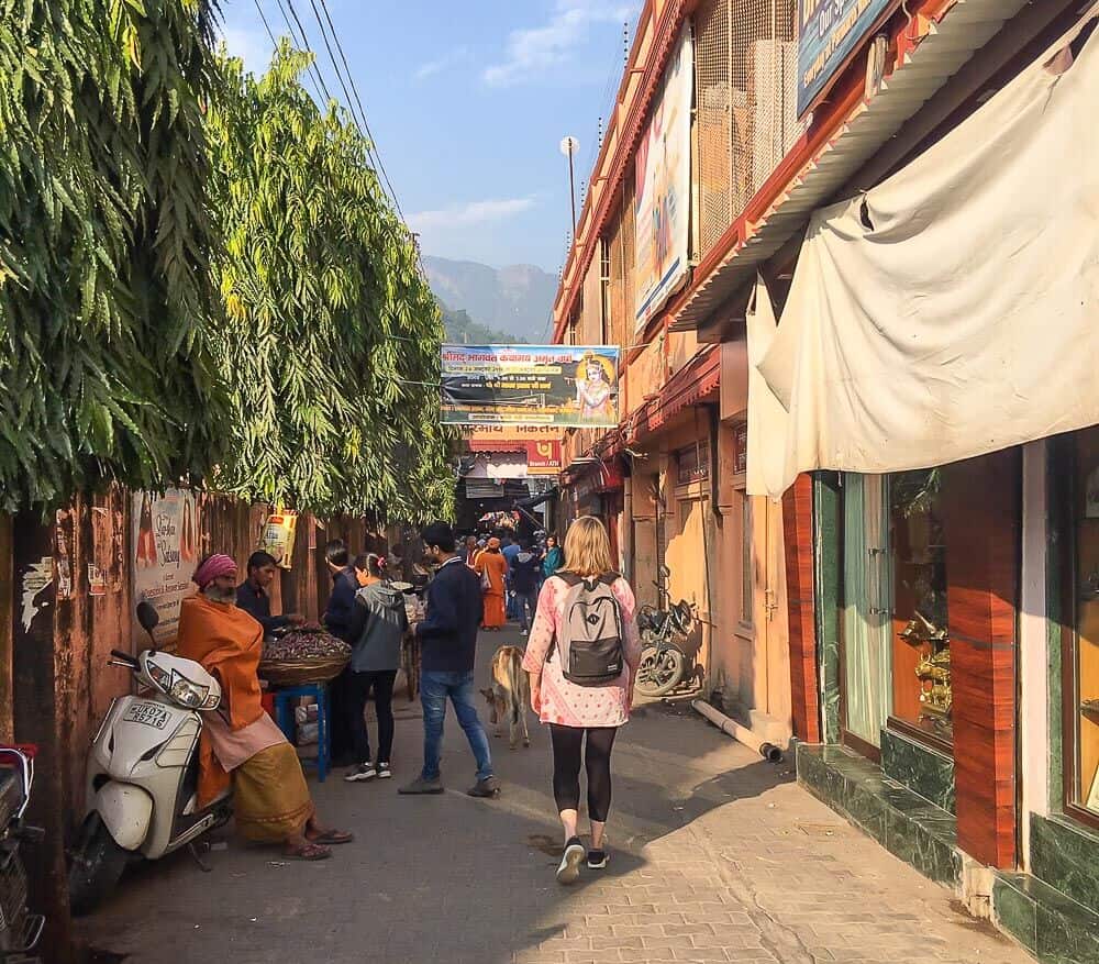 Mariellen walking through Rishikesh, India with backpack