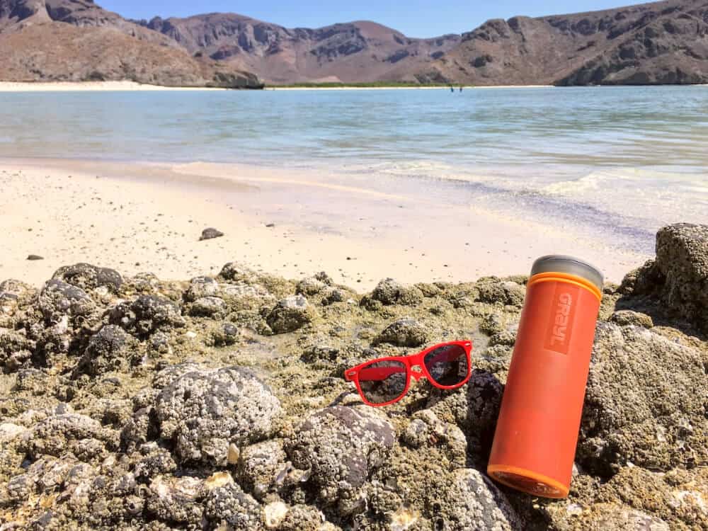 Water bottle with filter on beach