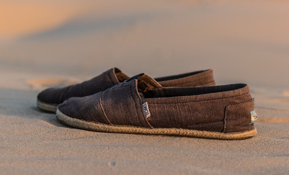 Brown canvas Toms Shoes on beach