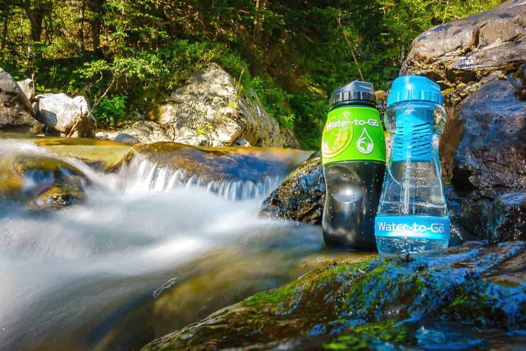 Responsible travel product water-to-go bottles and waterfall