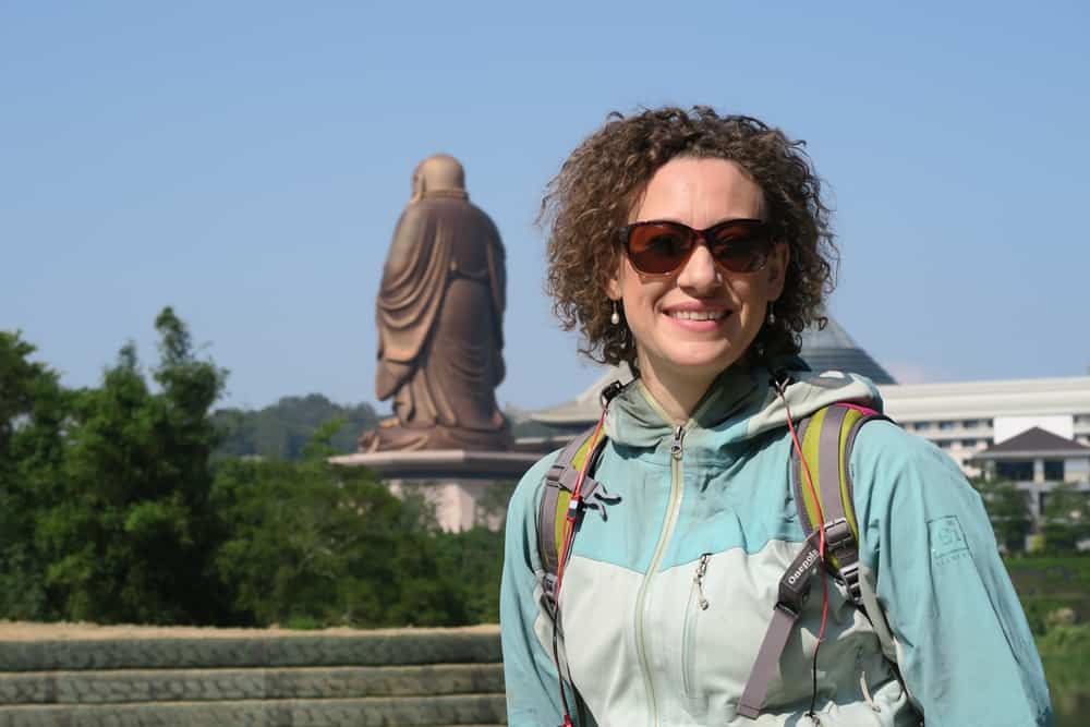 Woman in Asia wearing raincoat and backpack