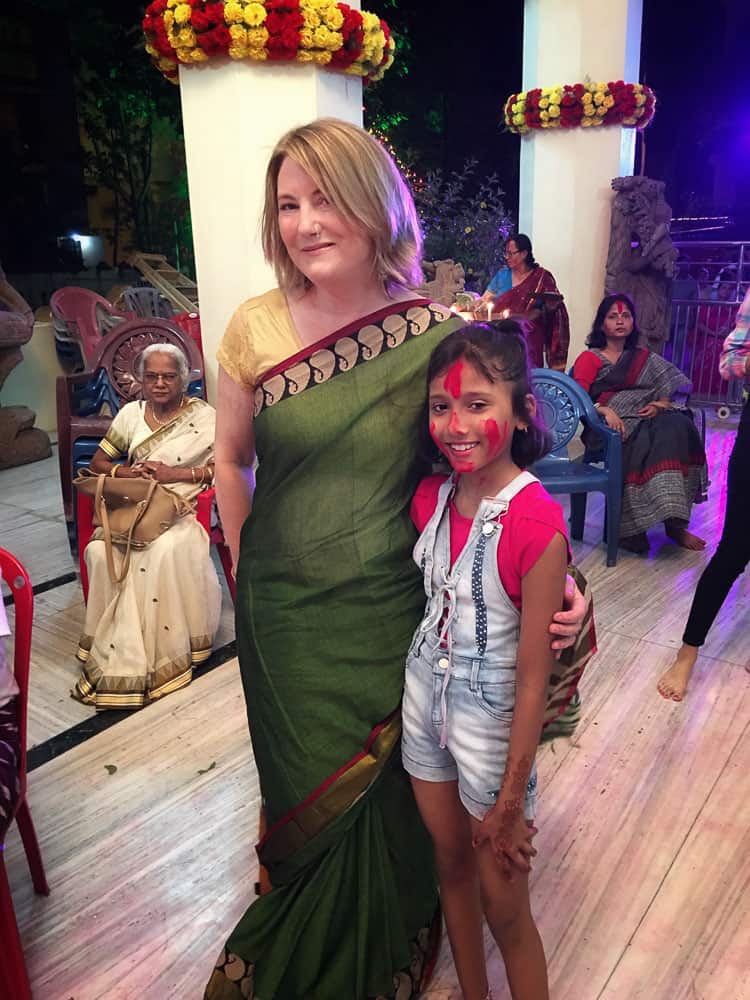 MW wearing green sari and hugging a girl at Durga Puja