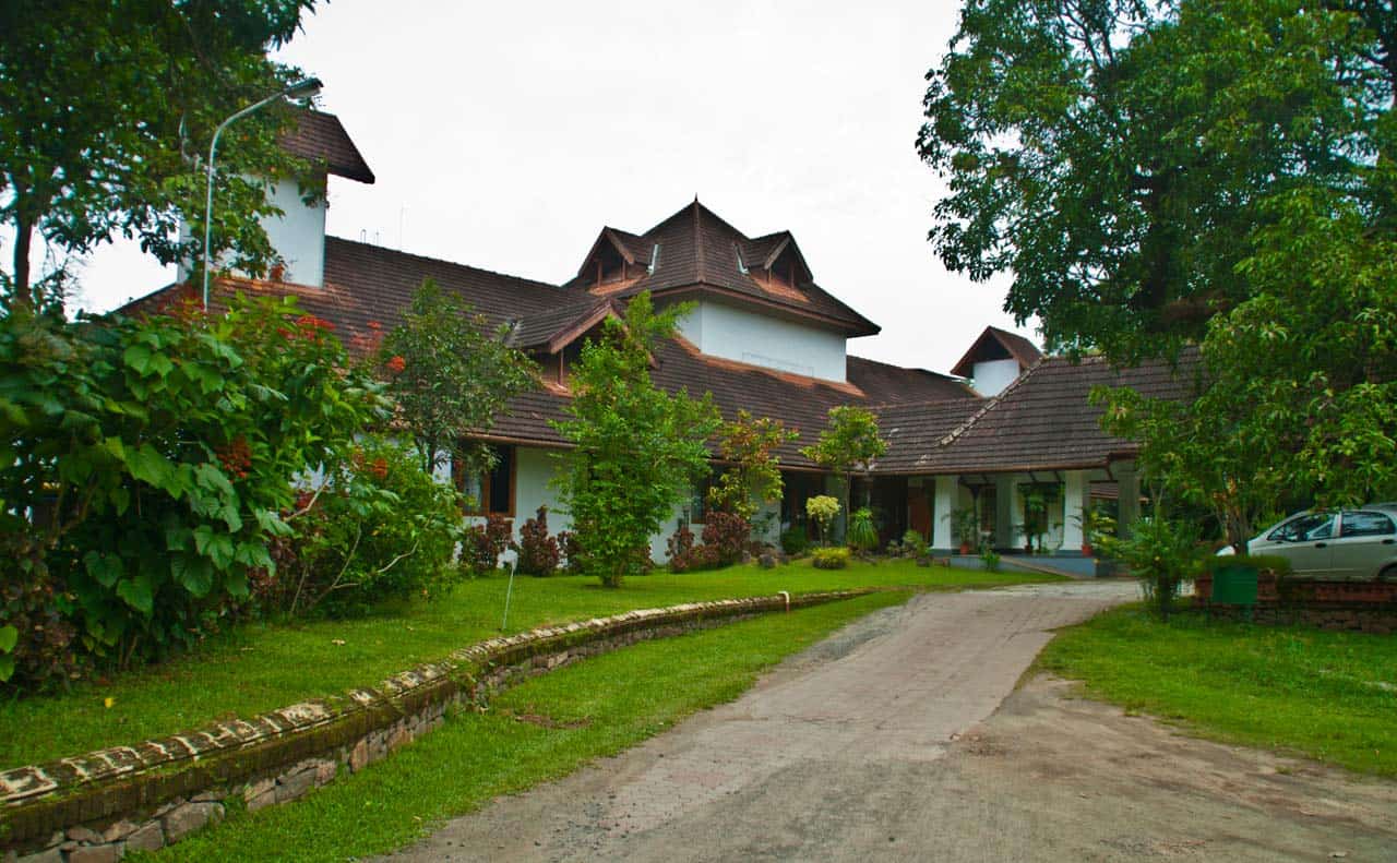 driveway, lawn, and red-tiled building in Kochi, India