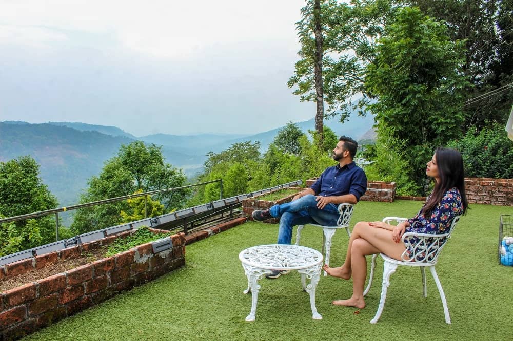 couple looking at hills of Munnar, Kerala