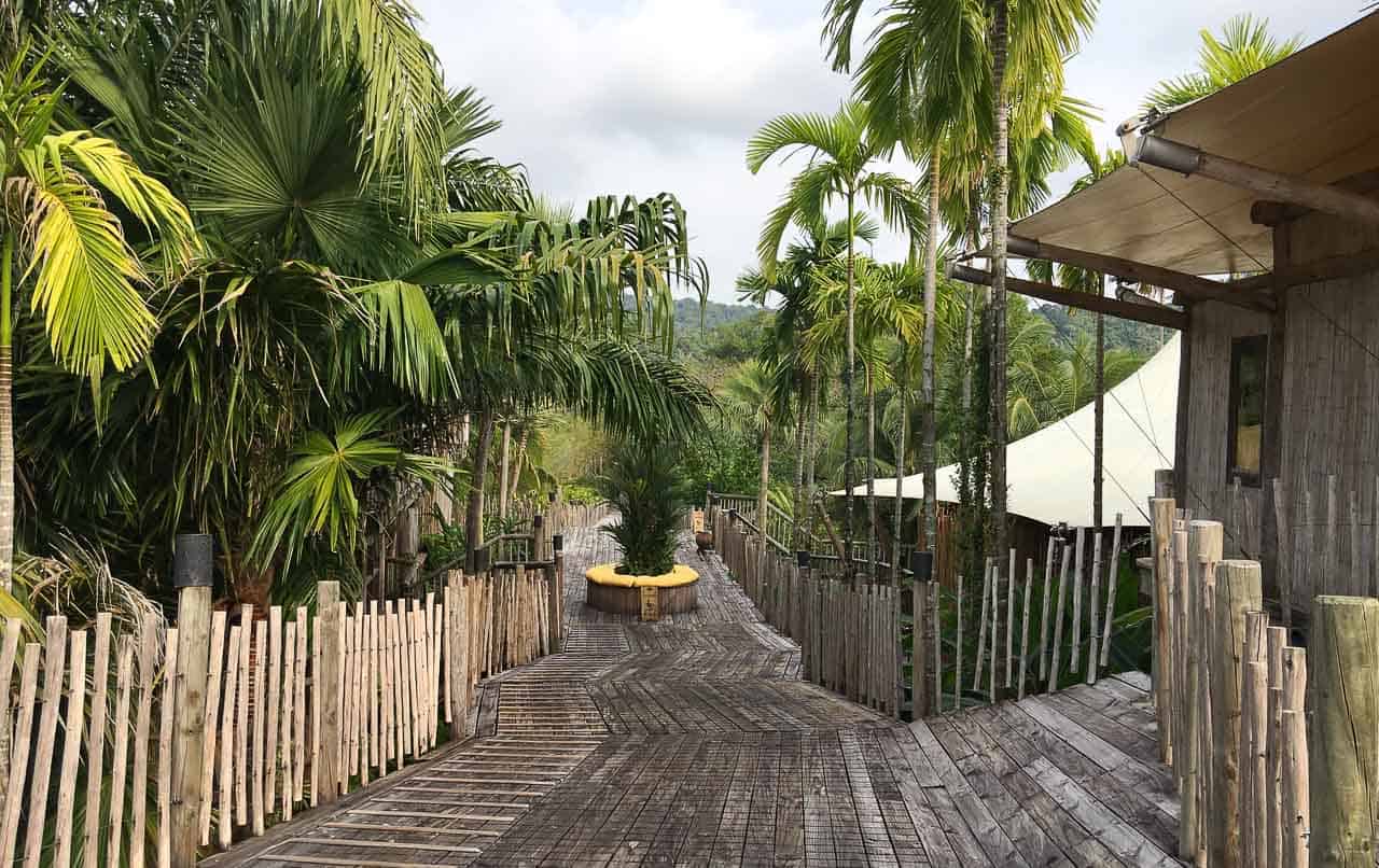 wooden walkway with trees at Thailand resort Soneva Kiri