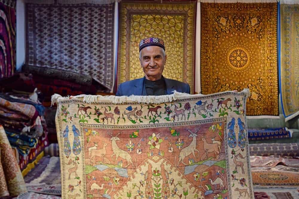 man selling carpets in Uzbekistan