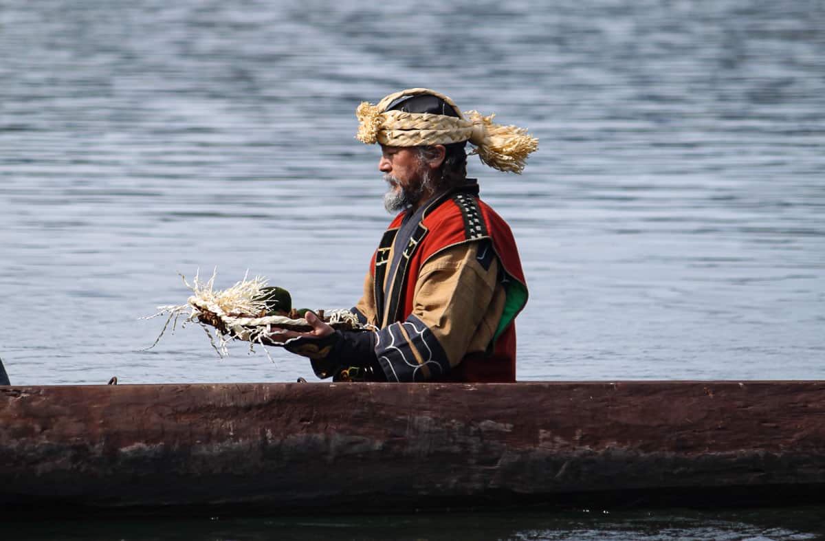 Ainu man in canoe, Hokkaido, Japan