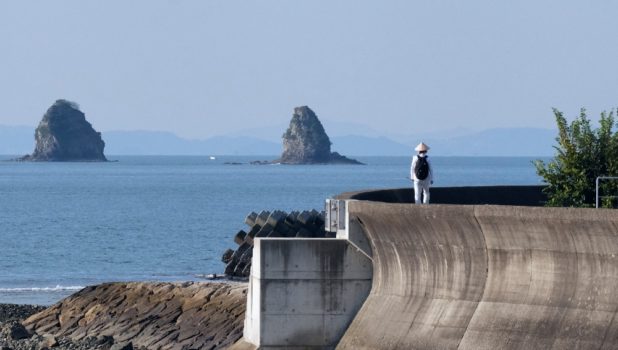man walking by sea in Shikoku, a place to visit in Japan