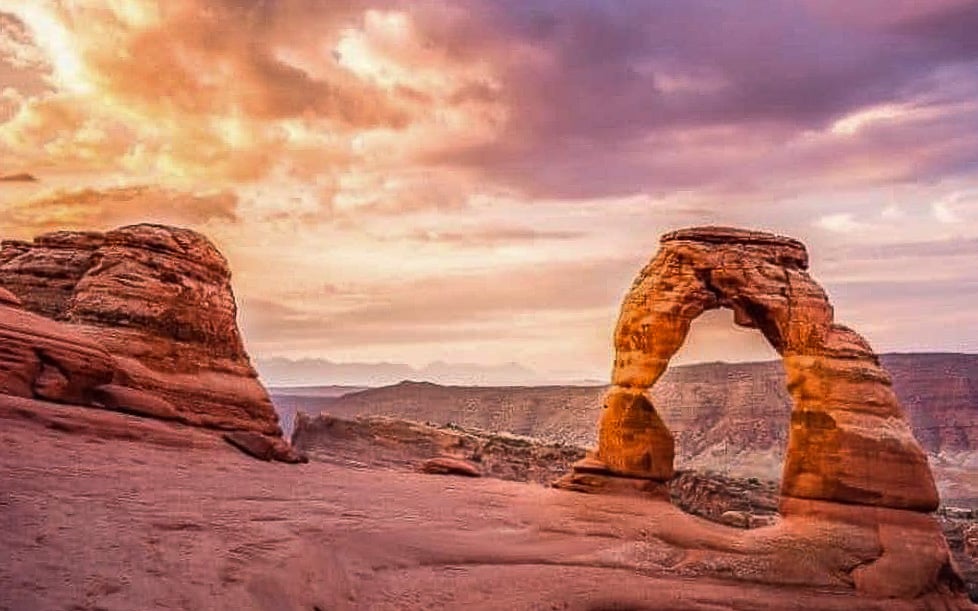 A stone arch in Southwest USA during monsoon travel