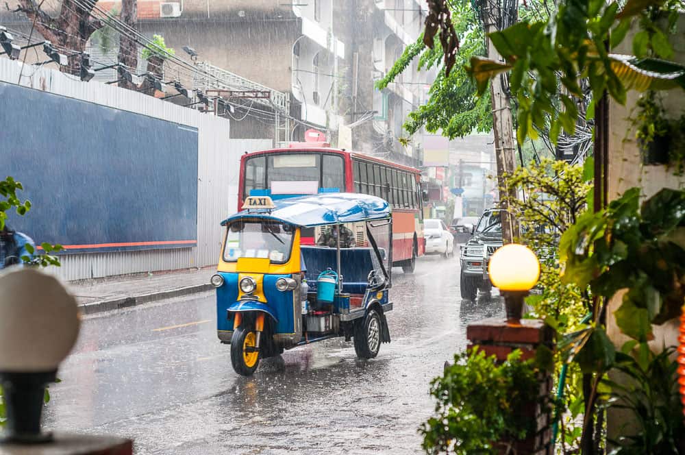 Tuk tuk speeds through the rain in Bangkok, Thailand.