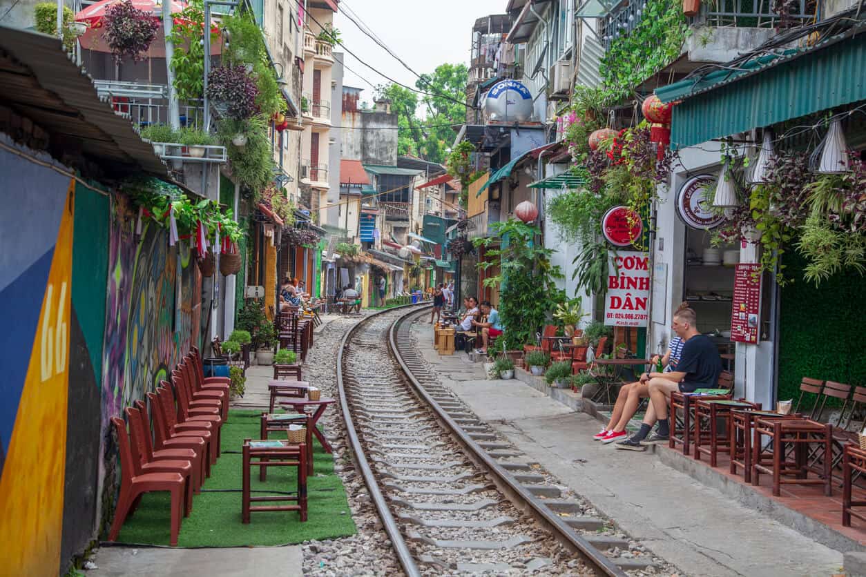 Street in Hanoi, Vietnam with train tracks running through.